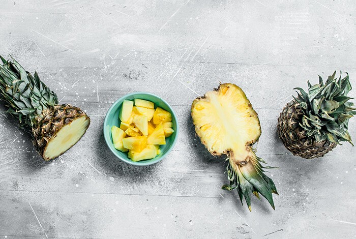 pieces of fresh pineapple with greens and sliced