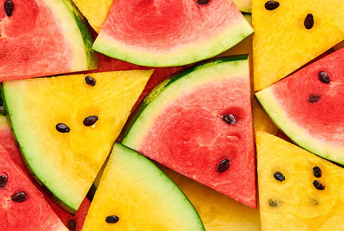 Triangle slices of red and yellow watermelons.