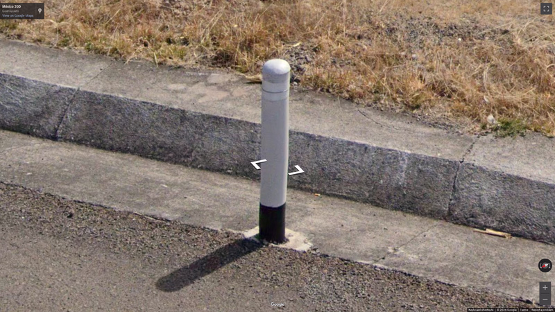 Grey bollard with reflectors