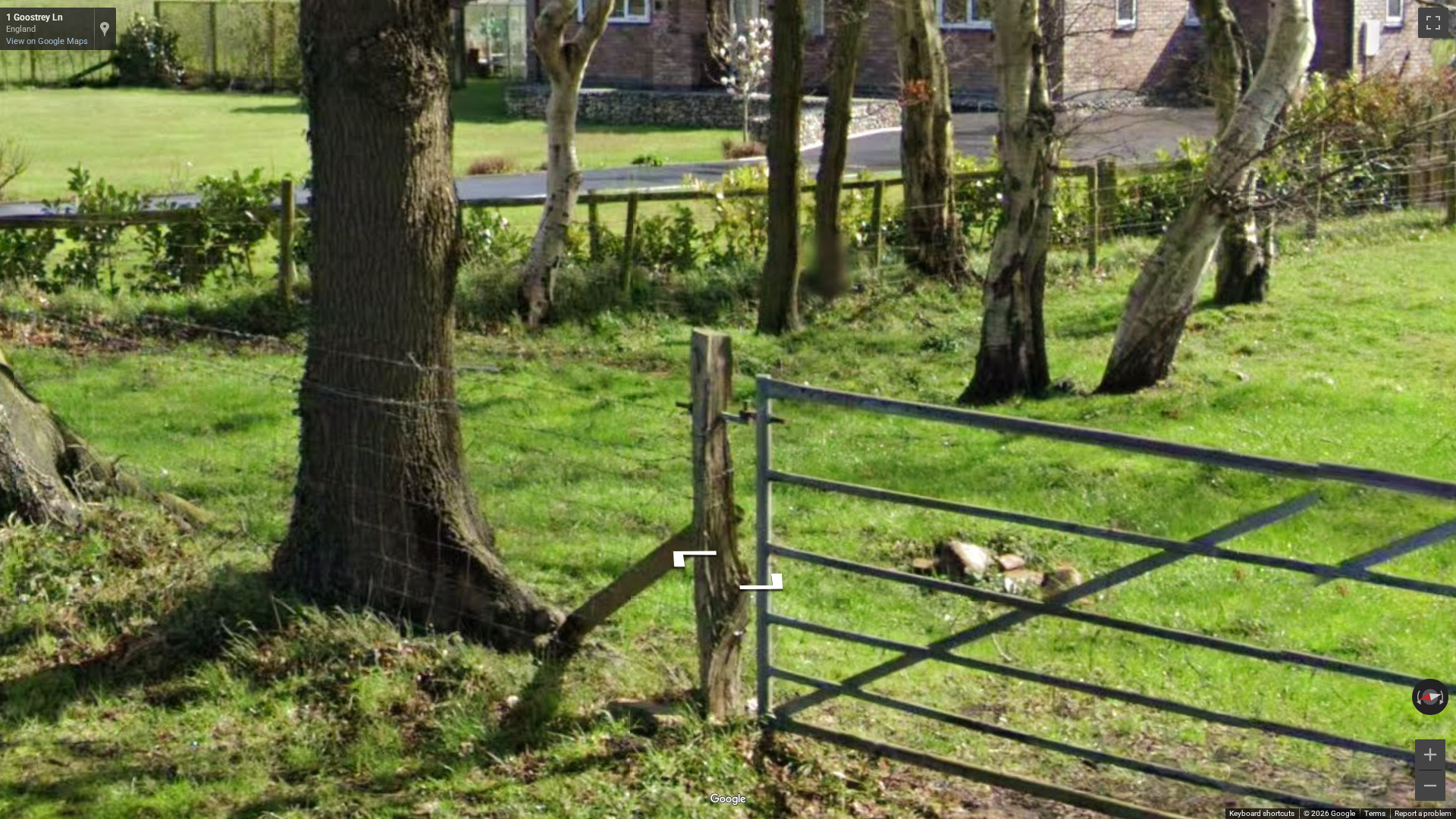 British metallic gate with square corners, often used in rural areas, contrasting with rounded Irish gates.