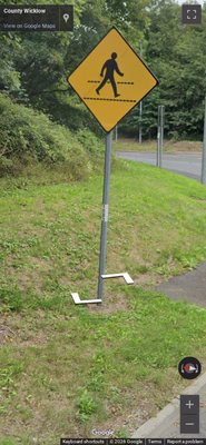 Ireland clue: White stickers on sign posts