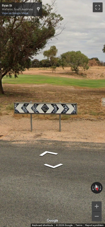 Australian road sign showing a black chevron with white arrows pointing to the right.