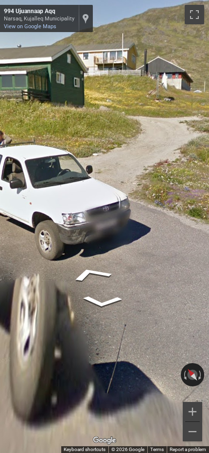 Greenlandic license plate, long and fully white, with a red outline that is often hard to see.