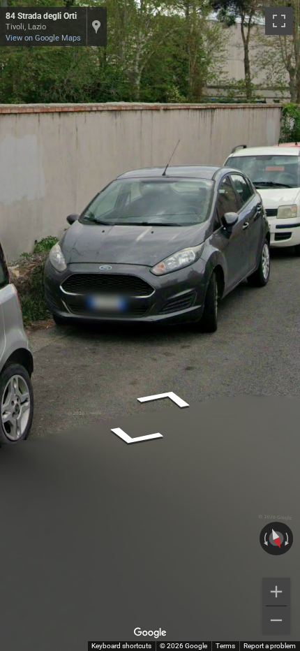 Italian front license plate, short in length, with blue stripes on both the left and right sides.