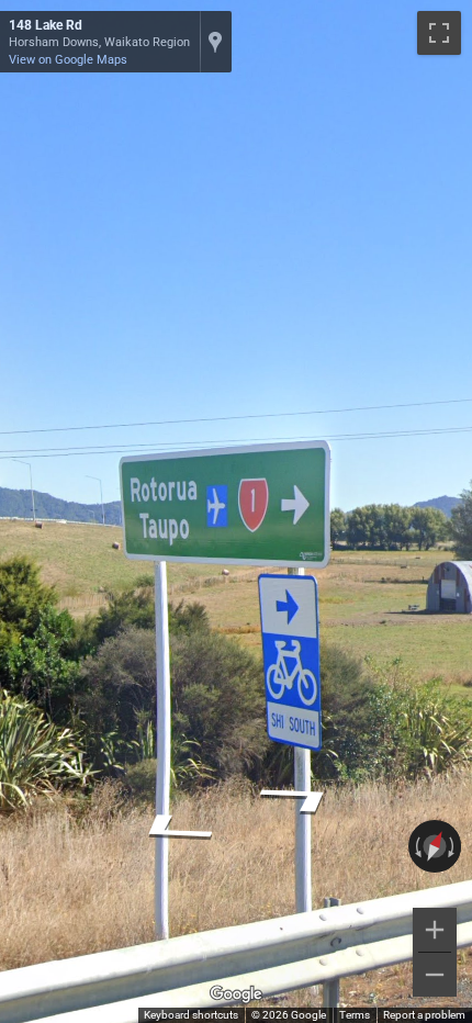 New Zealand highway shield with a red background and white numbers, contrasting with Australian signs.