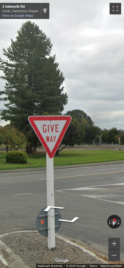 New Zealand give way sign with a red triangle border and red letters, contrasting with Australian signs.