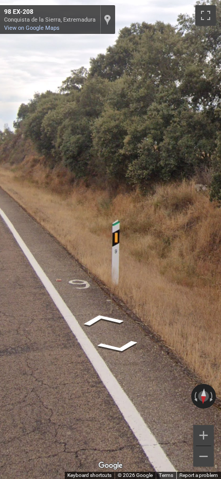 Spanish bollard with a green top, typically seen on regional roads within the Extremadura community.