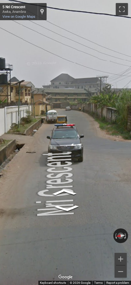 Nigerian police escort vehicle with flashing lights following the Google Street View car on a road.