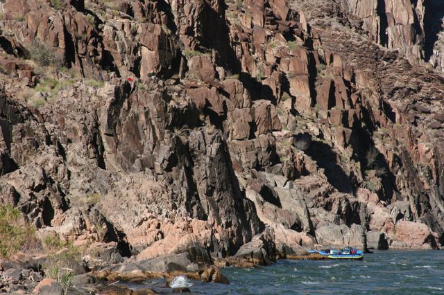 Jess watching from high up on the rocks, with the boats tied up below