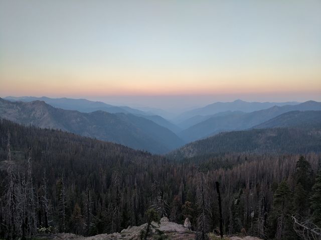 Pretty sunrise over smoke-clogged valleys