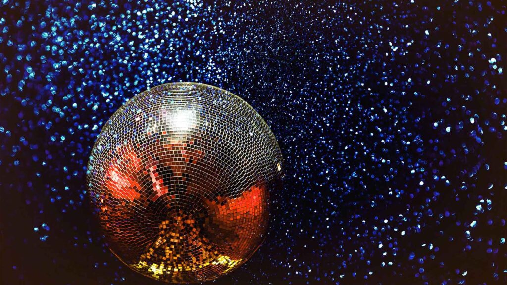 Silver disco ball against blue backdrop