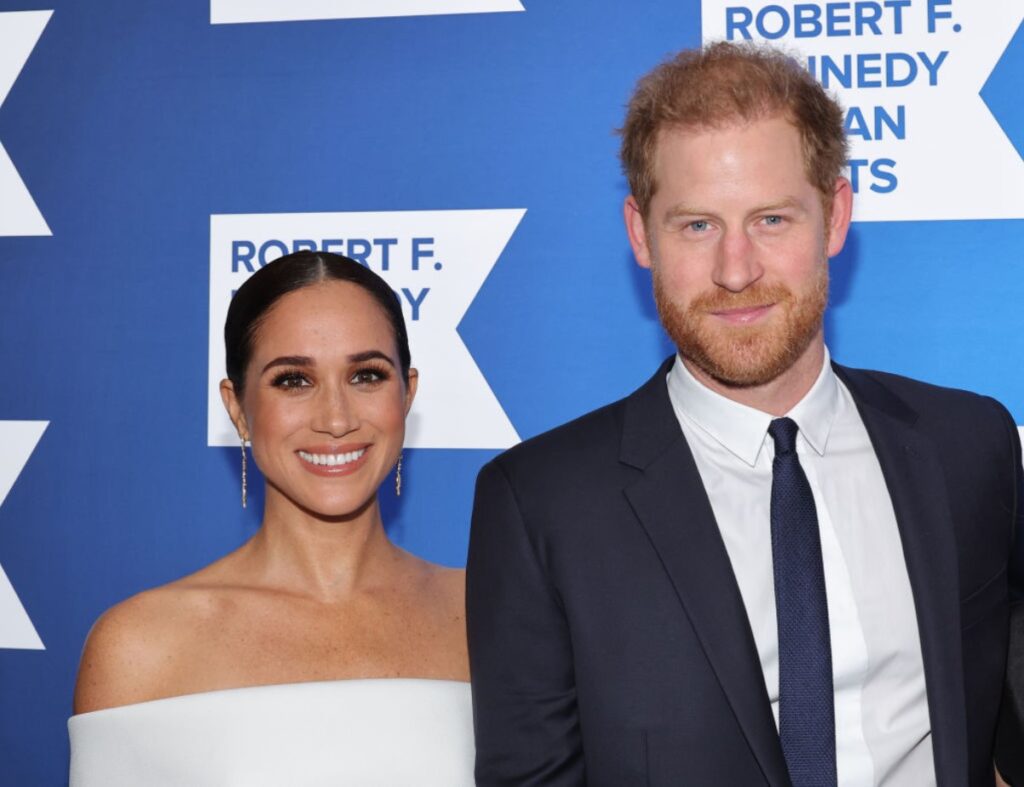 Meghan Markle pictured in a white dress as she stands beside Prince Harry during an event in New York City