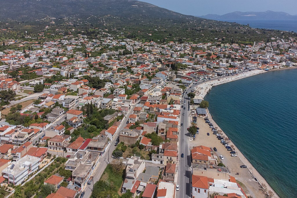 Aerial view of the coastline and neighborhoods of Amarynthos, Greece