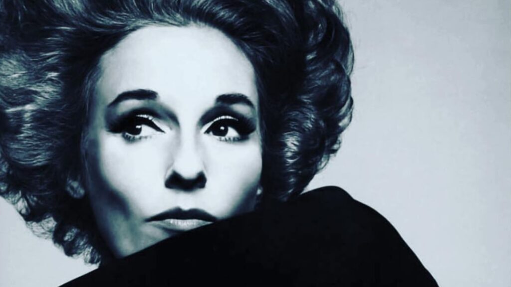 A black and white image of Babe Paley. Her hair is up and she is looking to the side of the camera.