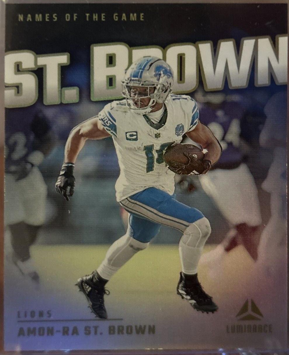 Amon-Ra St. Brown #NG-ASB Football Cards 2024 Panini Luminance Names of the Game