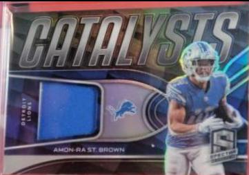 Amon Ra St. Brown #CAT-AST Football Cards 2022 Panini Spectra Catalysts