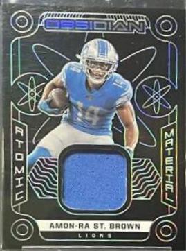 Amon Ra St. Brown #AM-AST Football Cards 2022 Panini Obsidian Atomic Material