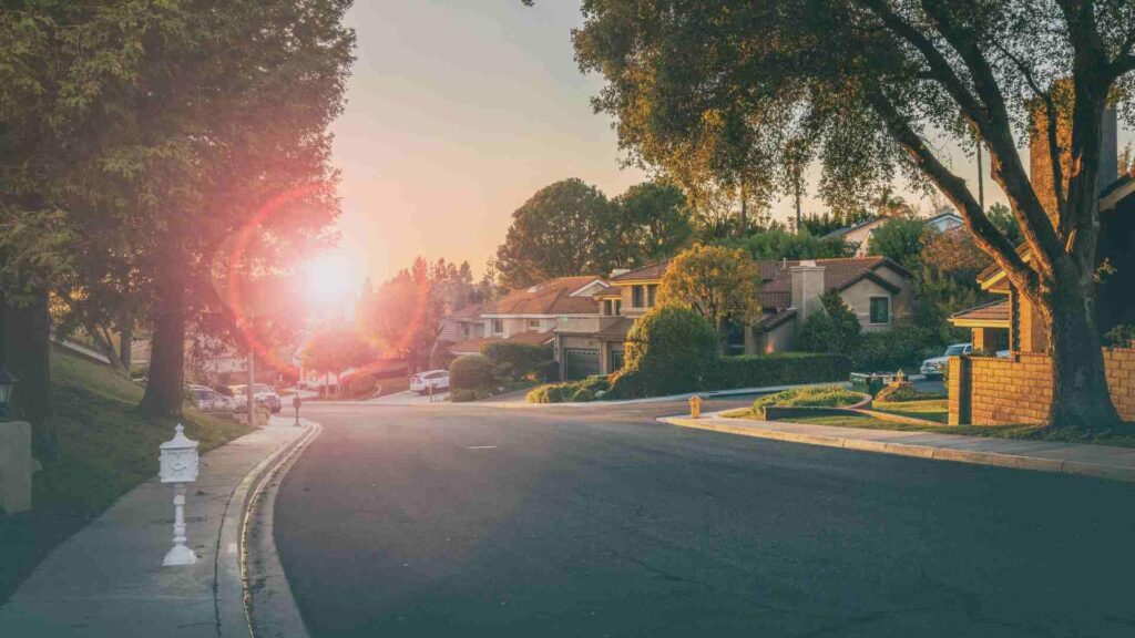 A winding road through a suburb as the sun sets