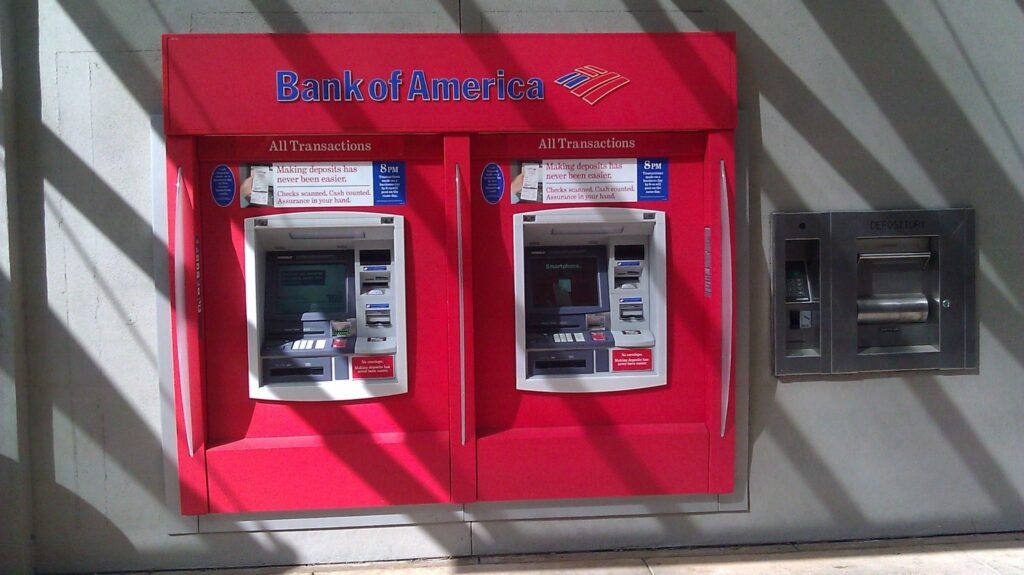 A photo illustration of two Bank of America cash machines on a busy city street