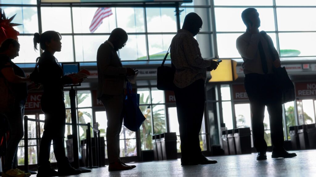 Silhouettes of people standing in line for job interviews.