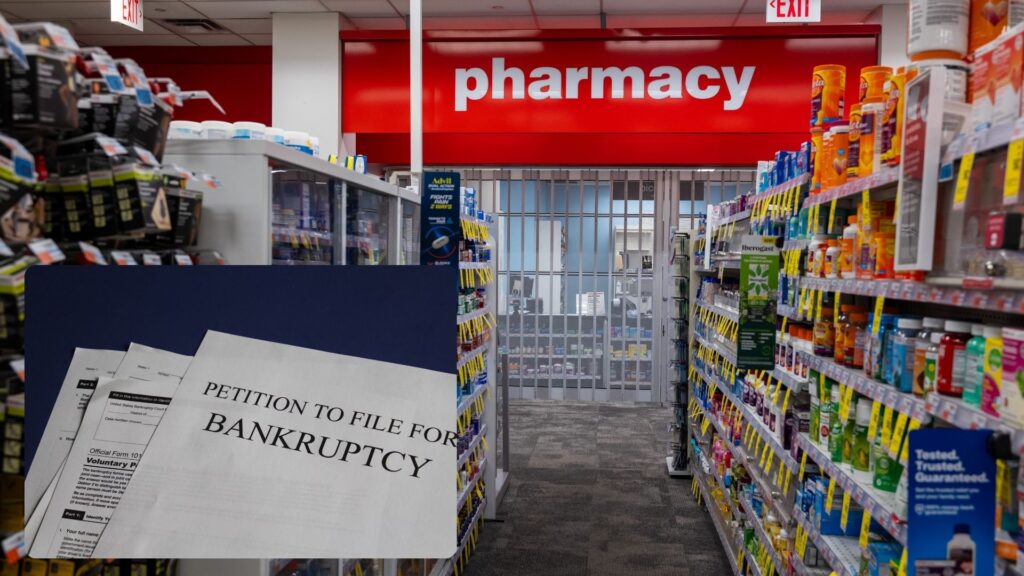 A red pharmacy sign in a store with the shutters down. In the bottom left-hand corner are some pieces of paper that have "petition to file for bankruptcy."