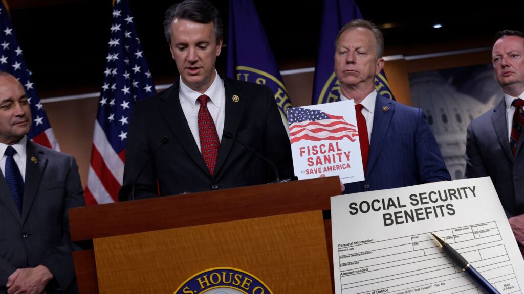 Republican Study Committee Budget and Spending Task Force Chair Rep. Ben Cline (R-VA) (C) speaks during a news conference with Rep. Bob Good (R-VA) (L), committee Chairman Kevin Hern (R-OK) and Rep. Eric Burlison (R-MO) to introduce their FY2025 federal budget proposal at the U.S. Capitol Visitors Center. A social security benefits form with a pen is imposed on top