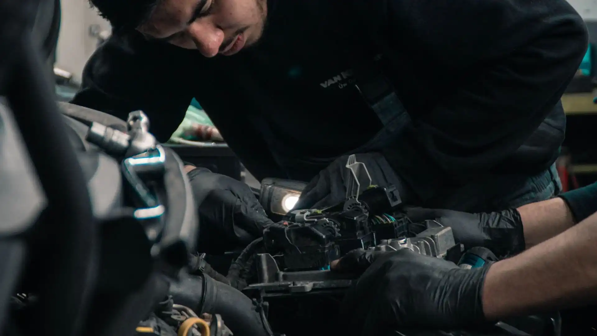 Man Looking Under Hood of Car