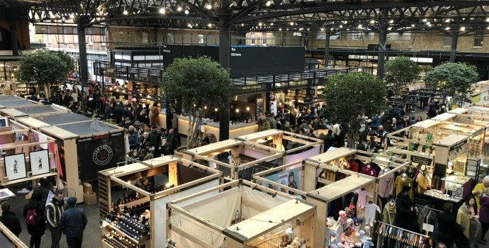 A vibrant East London market blending historic charm with modern food, fashion, and culture.