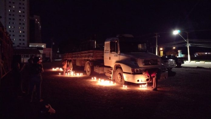 Família acende velas em manifestação para casal vítima de carga de caminhão