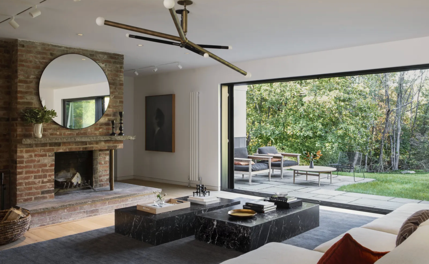 Warm minimalist Connecticut home with wood surfaces, marble, and calm layered neutrals