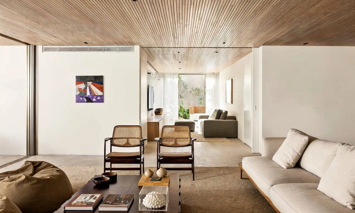 Modern warm minimalist living room featuring neutral-colored furniture and decors