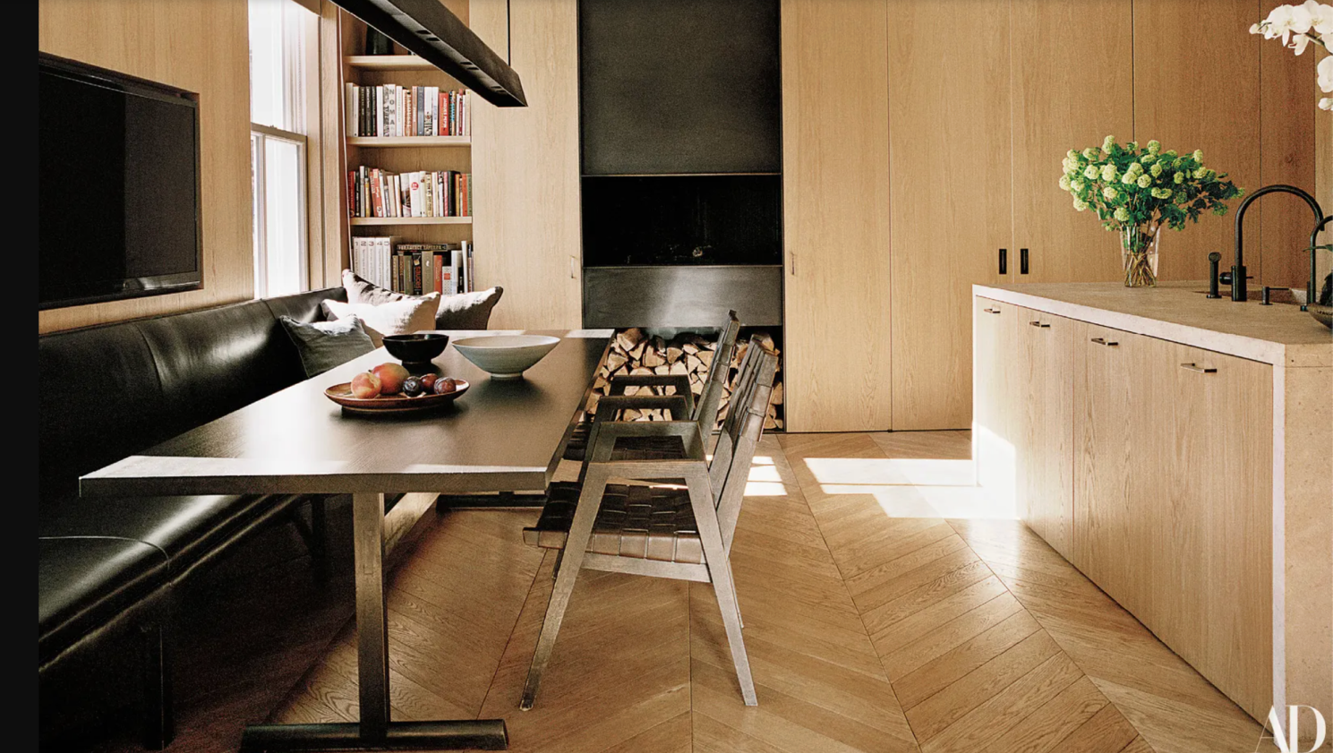 Warm minimalist kitchen featuring soft natural light, oak cabinets and furniture