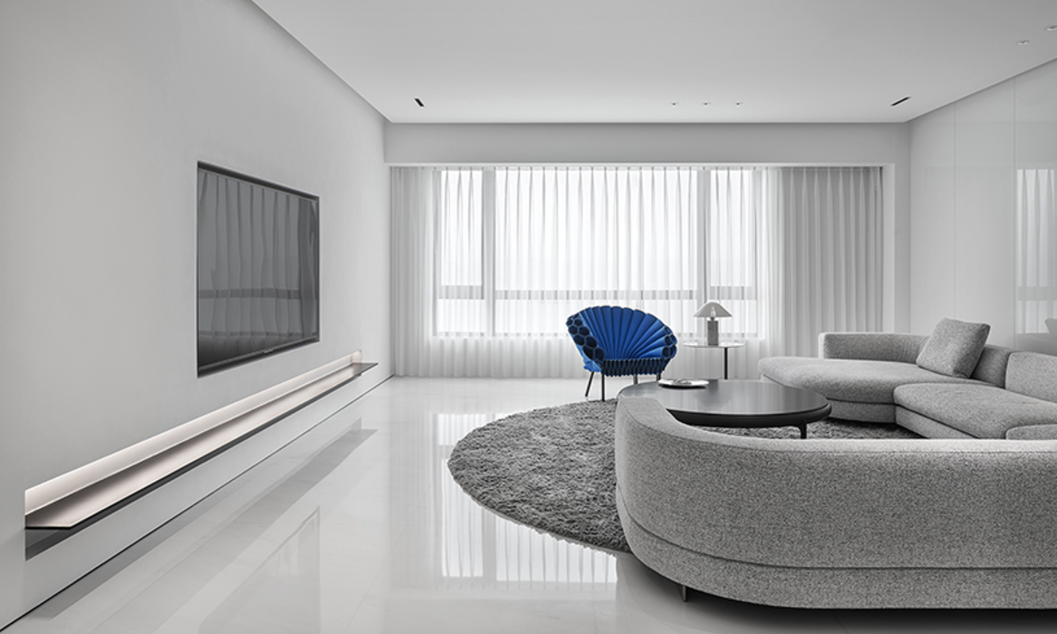 Minimal apartment interior in black and white with dramatic open space and restrained styling