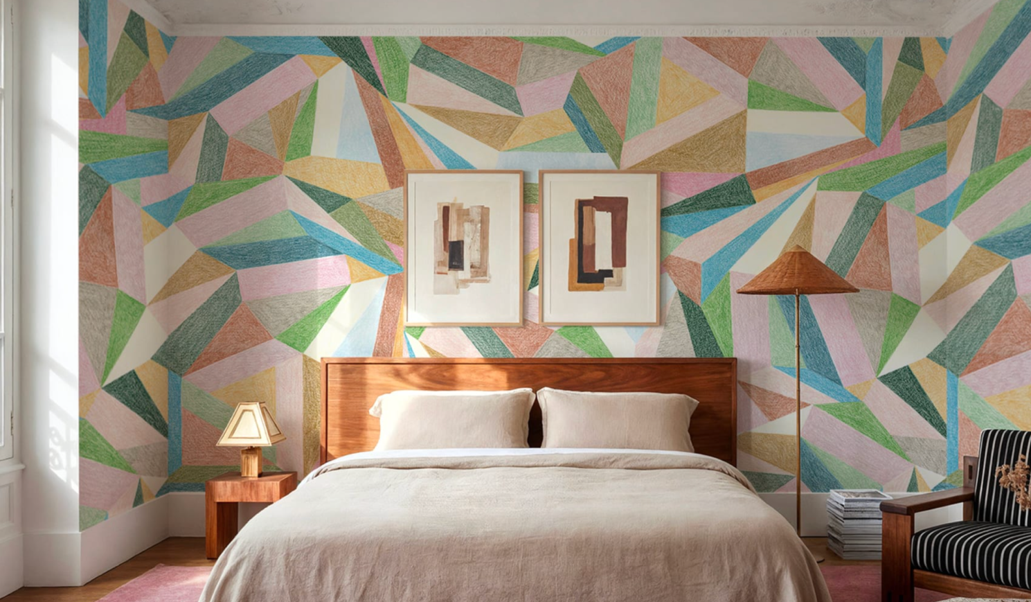 Geometric painted accent wall with muted green, yellow and clay shapes in a bedroom