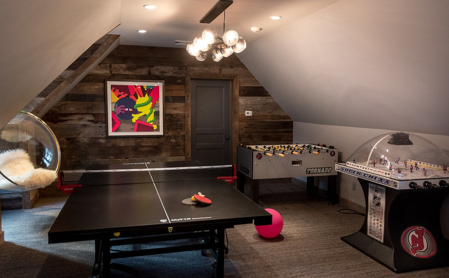 Attic game room with ping pong, foosball, stadium hockey, hanging chairs, and carpeted flooring