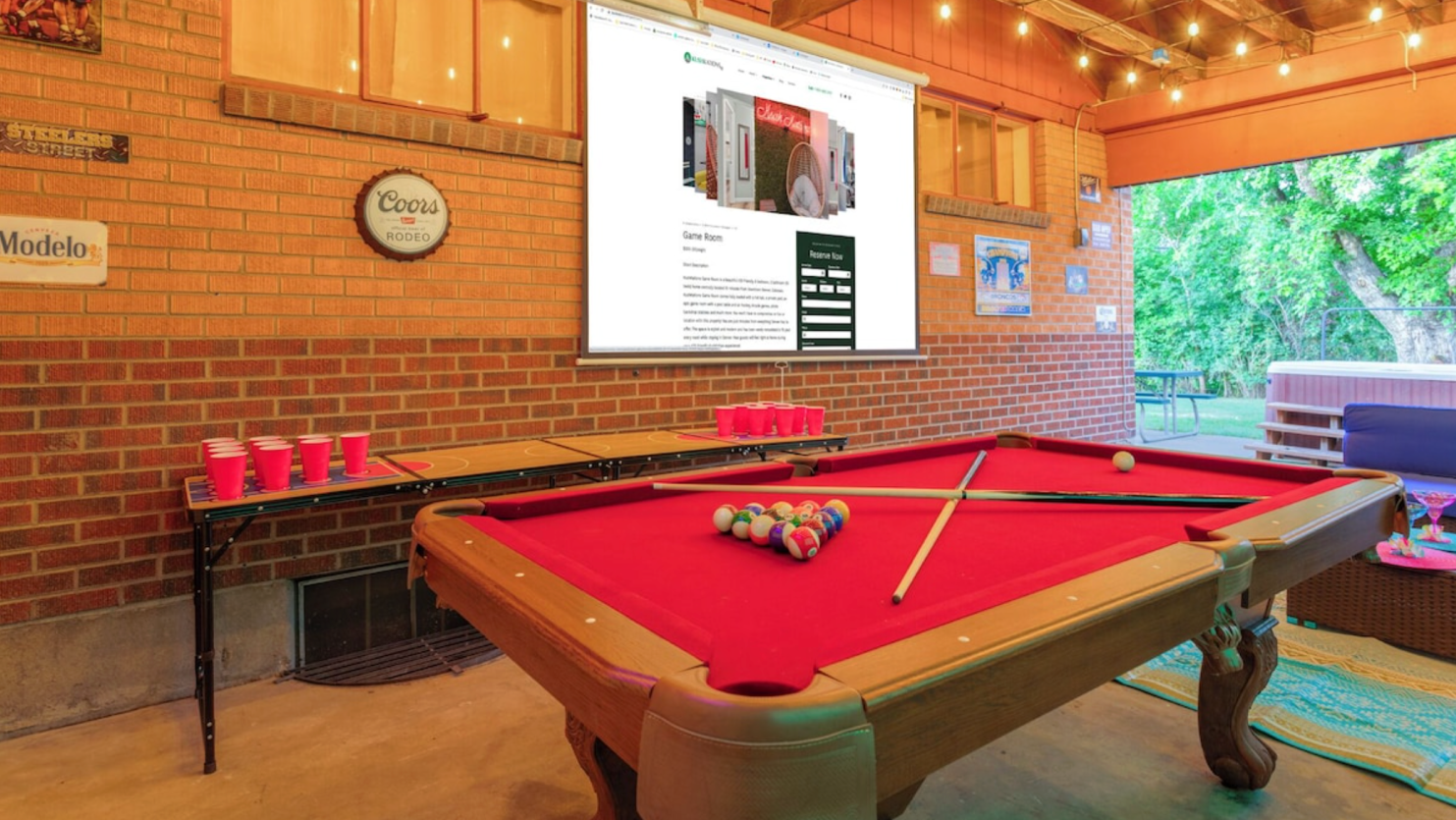 Adult billiards room with pool table, large opening doors, patio access, and relaxed indoor-outdoor flow