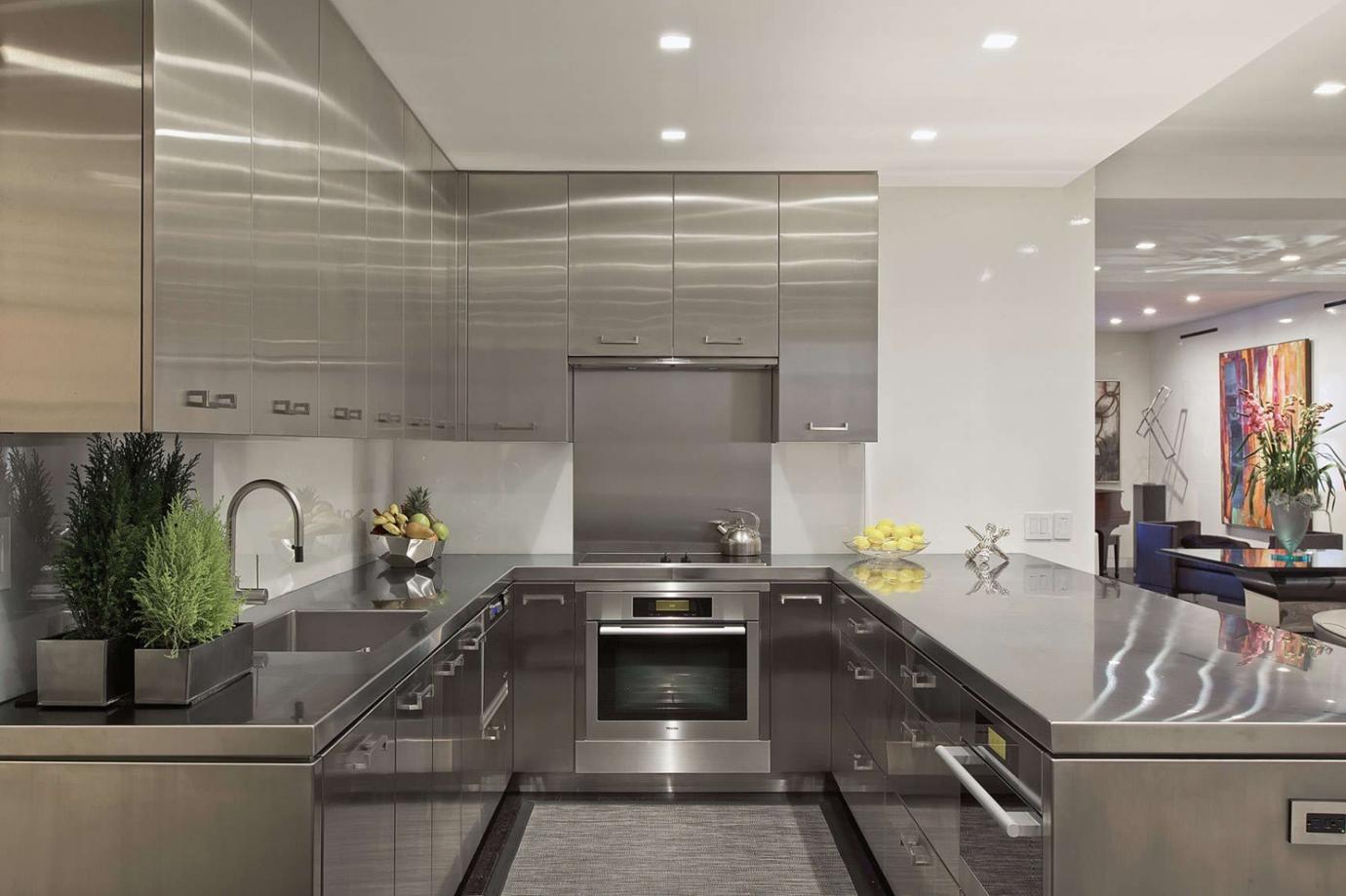 Modern kitchen with stainless steel cabinets, countertops, and appliances
