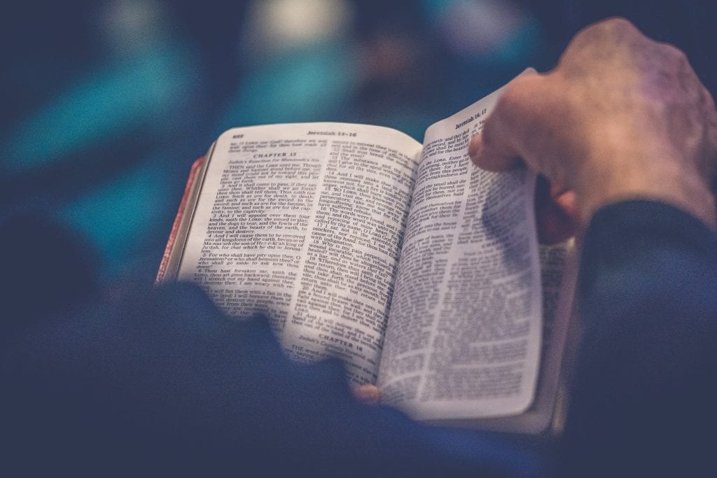 Man’s hands reading the Bible