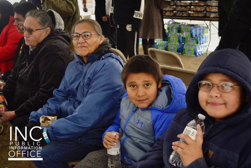 woman and children sitting down during the INC's event
