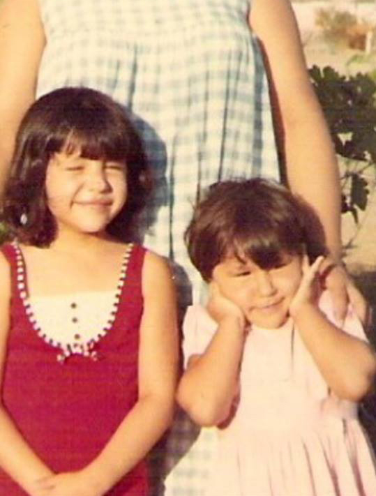 Two little girls smiling.
