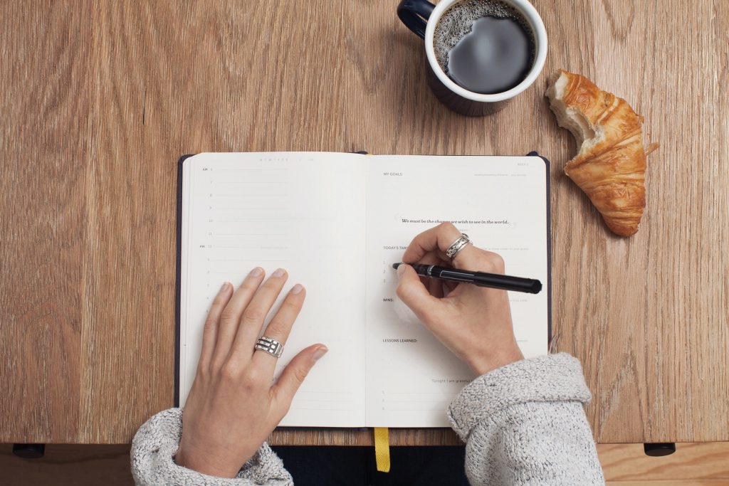 Woman writing questions on paper
