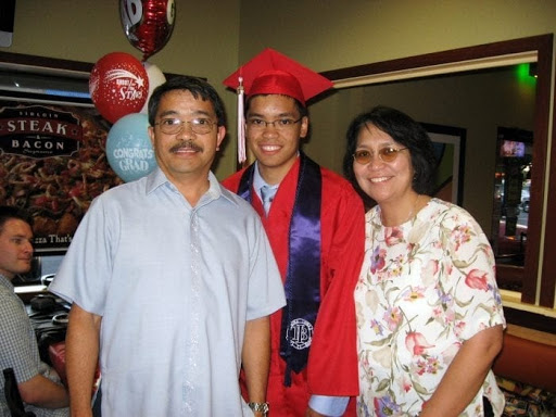 Paolo with parents at graduation party