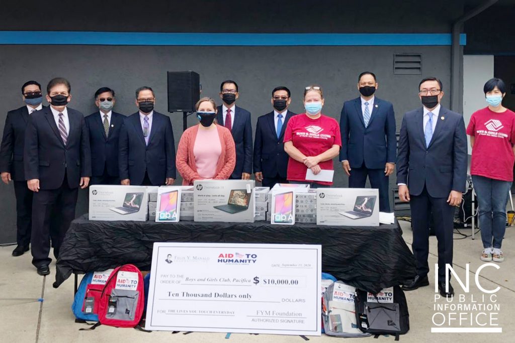 Representatives from the City of Pacifica, Boys & Girls Club and the Church Of Christ pose around a table with the donated chrome books and tablets.
