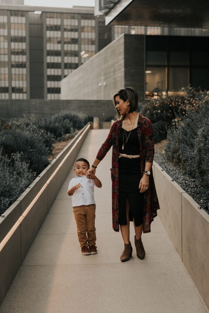 Son pulling back as mom walks forward. 