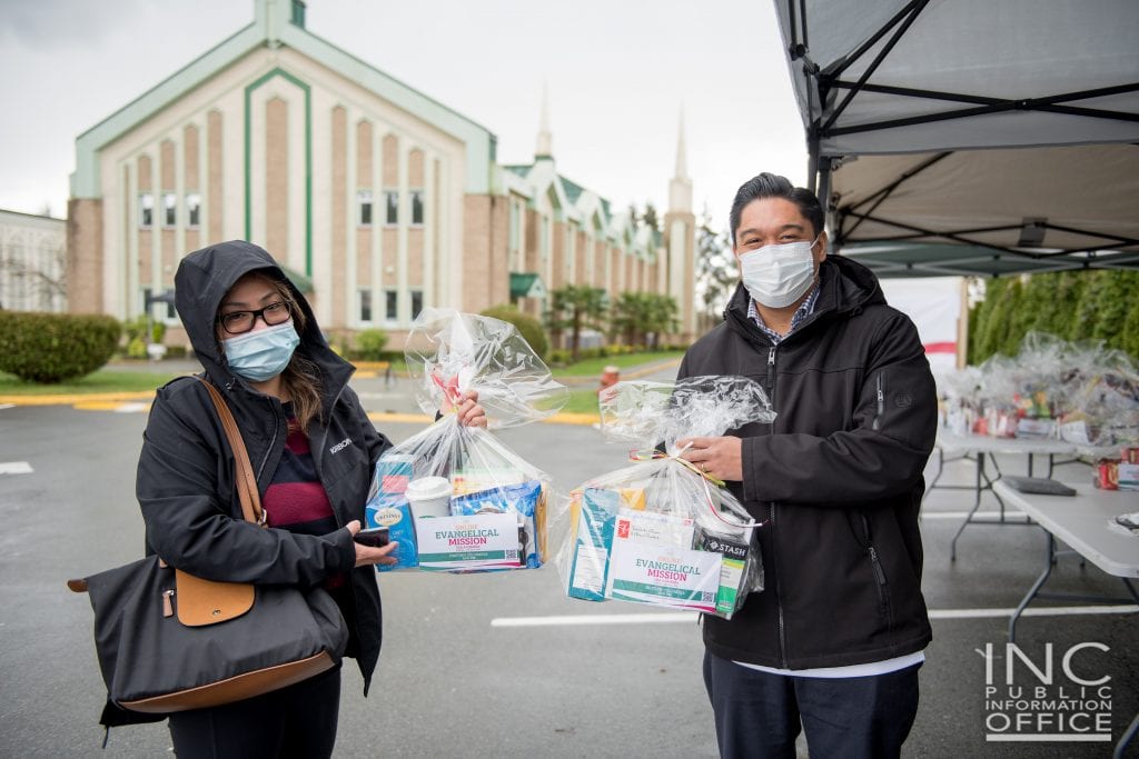 A minister from the Iglesia Ni Cristo (Church Of Christ) poses with a happy recipient of care packages provided during the Aid to Humanity event in Burnaby, Canada