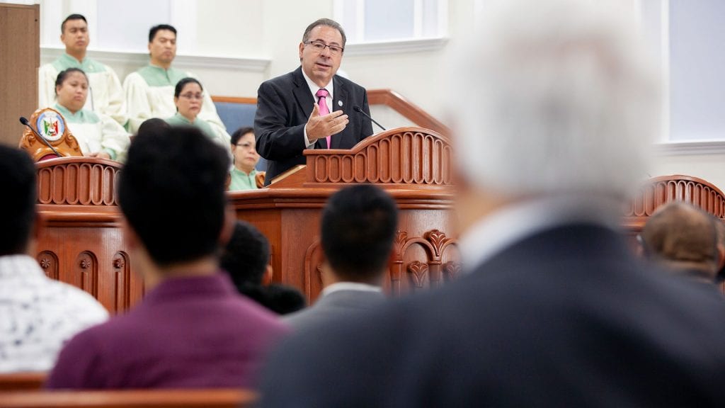 A minister preaching in front of a congregation.