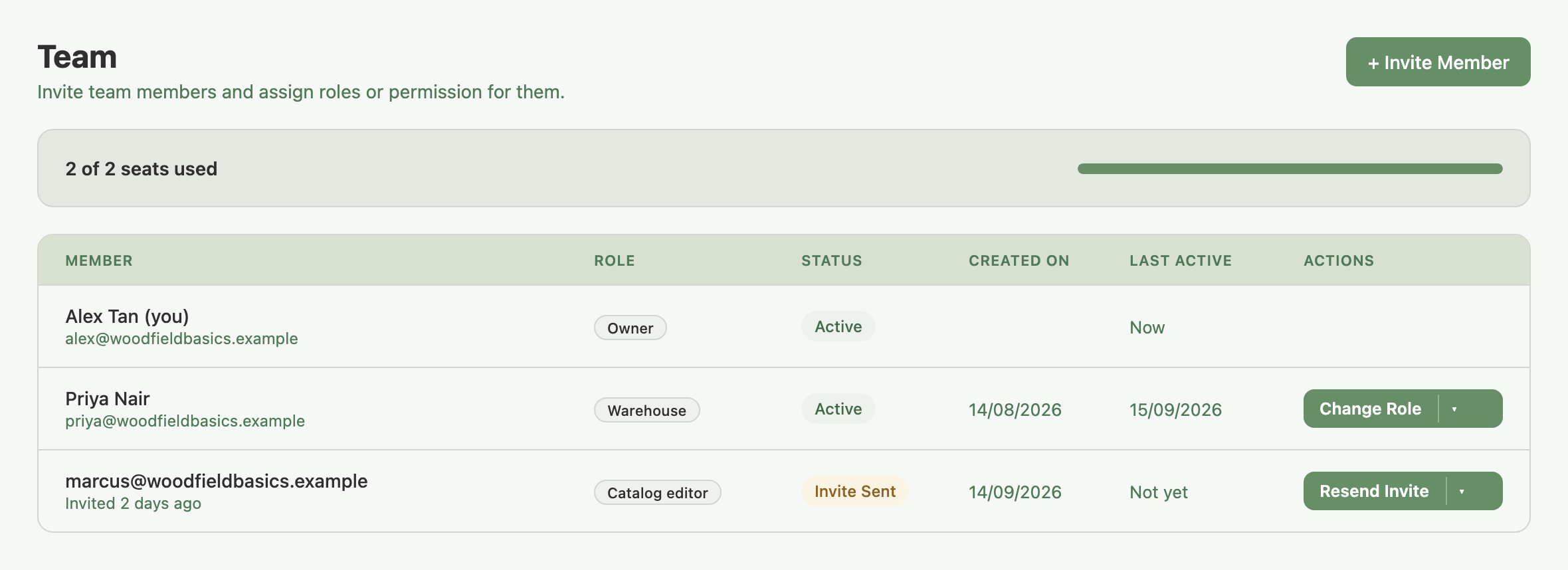 Settings > Team tab: seat meter reading 2 of 2 seats used, and the members table with Alex Tan (Owner, Active), Priya Nair (Warehouse, Active) and an Invite Sent row for marcus@woodfieldbasics.example (Catalog editor)