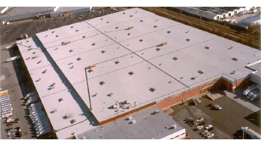 Commercial flat roof contractor All-Star Roofing Inc. evaluating roof conditions in Amity Harbor, NY