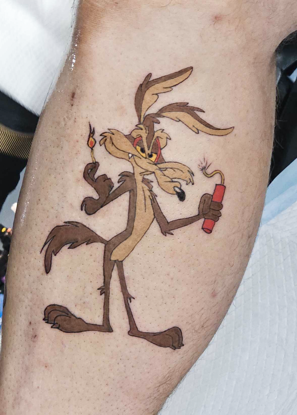 A fun illustrative tattoo featuring a cartoon character holding a bomb.