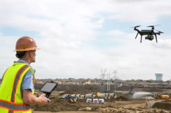 Drone being deployed in to survey & map a construction site.